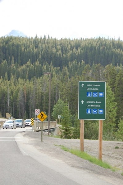 A sign points the ways to Lake Louise and Moraine Lake just off the Parkway