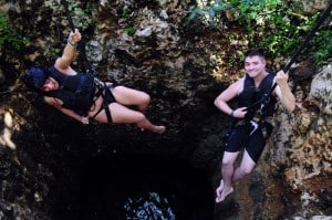 Rappelling into a cenote at Jungle Maya