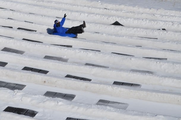 A guest flies down the tubing slope 