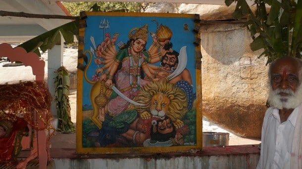 Sadhu in front of a painting around the temple