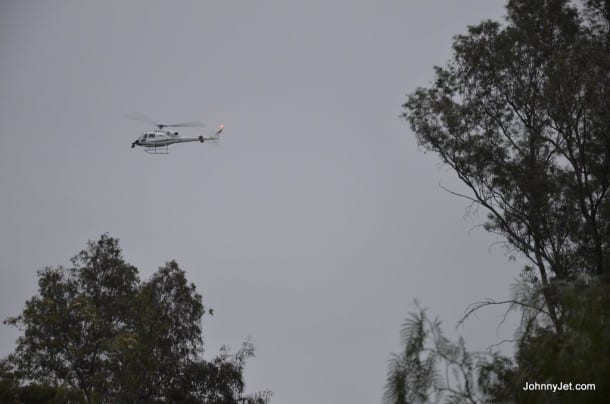 A helicopter hovers overhead