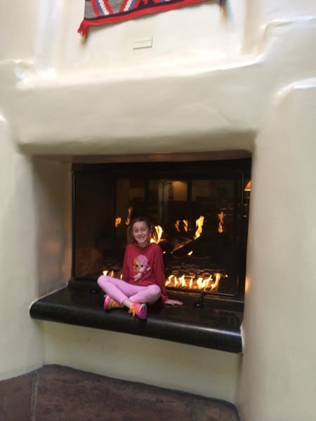 Charli waiting to check in and warming by the fire!