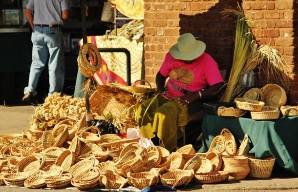 Gullah craftswoman making sweetwater baskets at Old City Market (Credit: Bill Rockwell)