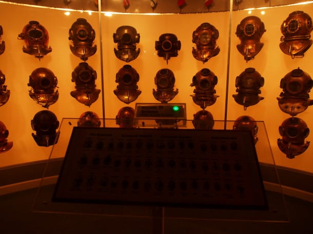 Wall of helmets at the History of Diving Museum