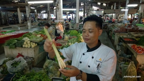 Chef from Anantara Hotel Chiang Rai taking guests of cooking school to local market