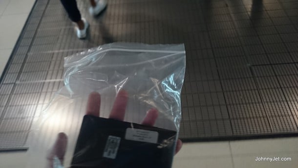 Putting your phone in a plastic bag through security