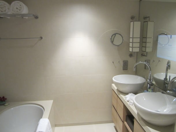 The bathroom is spacious enough for a tub, dual vanity and rainfall shower
