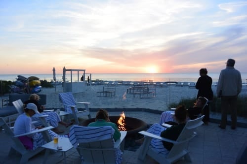 Fire pit and sunset out near the pool