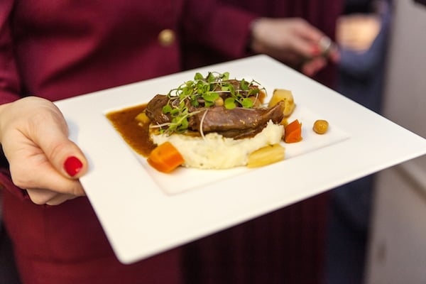 Braised lamb shank with chickpea and saffron sauce, parsley mashed potato, and roasted root vegetables (Credit: Russ Kuhner)