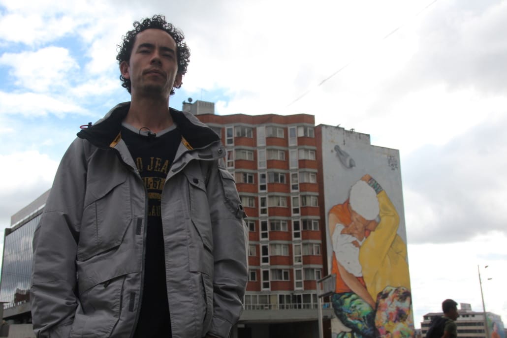 An artist with his work in Bogotá