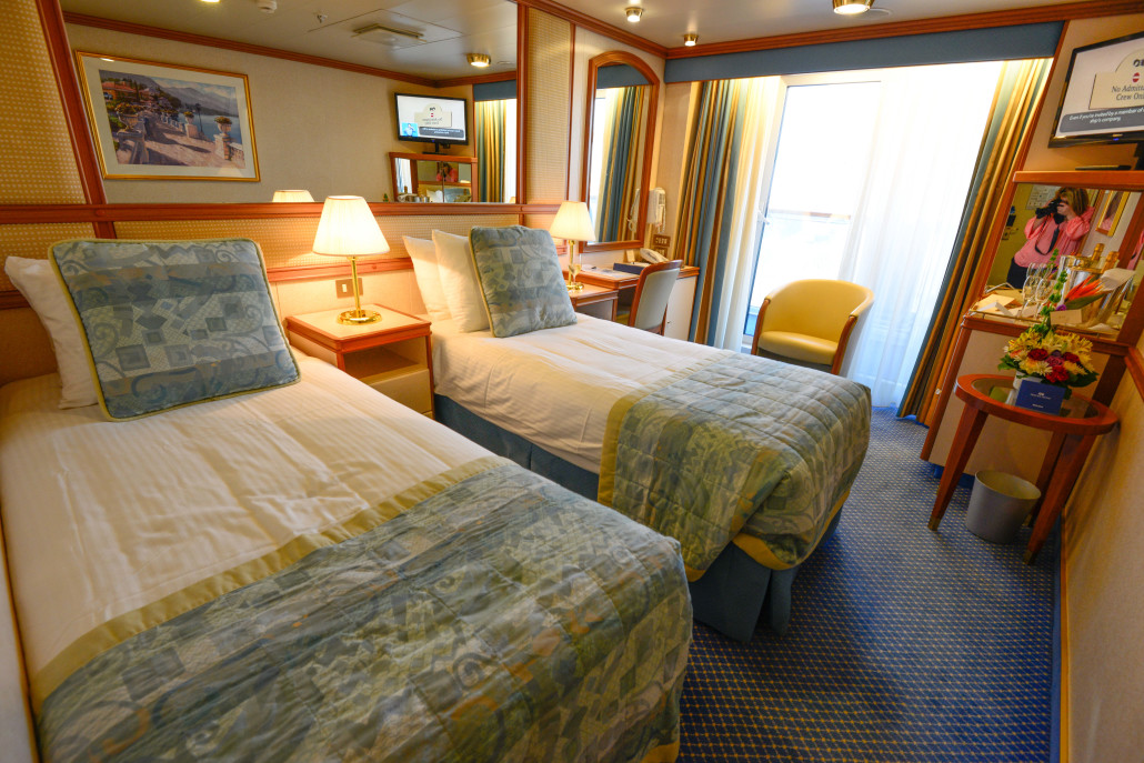 Our stateroom with a balcony was snug and waiting with a basket of flowers and champagne