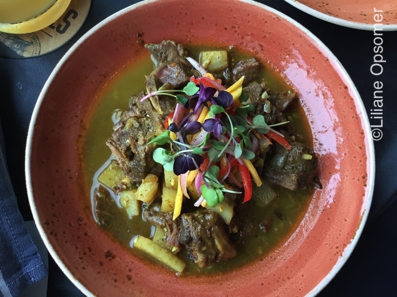 "Jamaican Curry Goat" dish with Scotch bonnet, curry, potatoes, and thyme