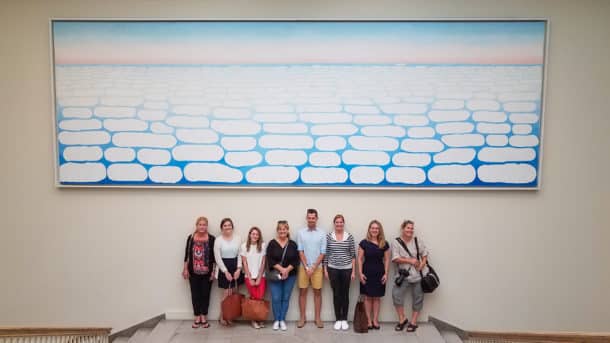 Our group standing beneath "Sky above Clouds IV," 1965, by Georgia O'Keeffe