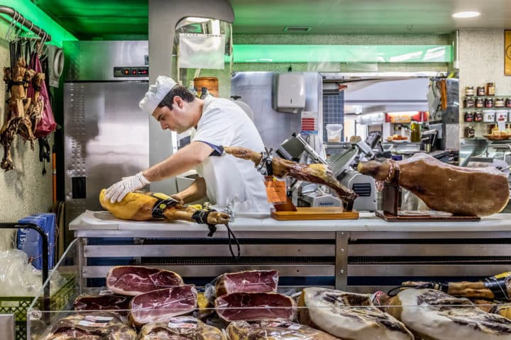 Carving ham at the Faro Municipal Market