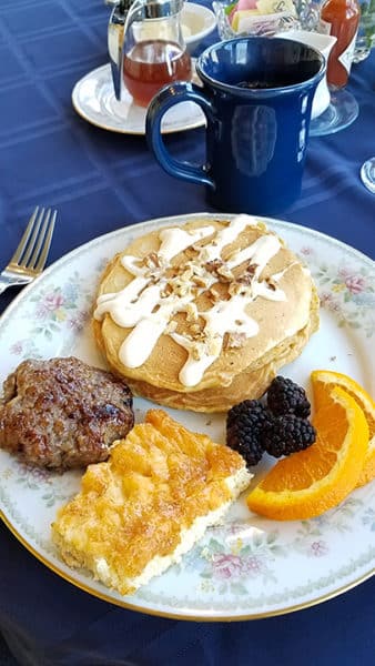 Breakfast at the Blue Goose Inn: carrot cake pancakes, quinoa with roasted blueberries, apple maple sausage patties, and hand-pressed cider from apples grown in the backyard