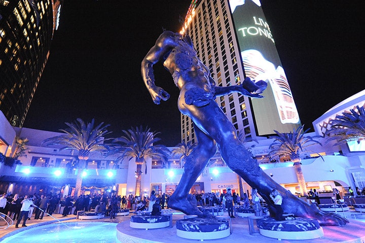 A 60-foot bronze Damien Hirst sculpture and 270-foot LED screen towers above guests