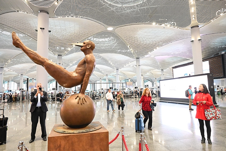Passengers stopping to take notice of art just outside of security at Istanbul Airport