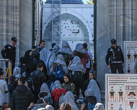 Visitors complying with the modest dress code before entering Sultan Ahmed Mosque