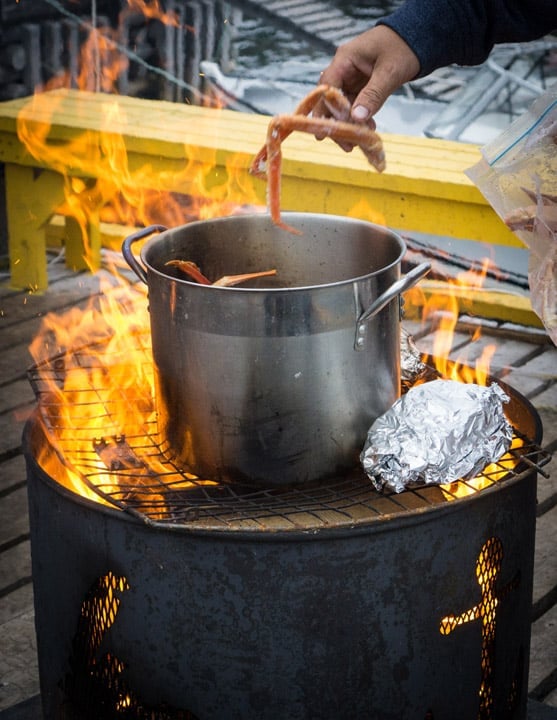 Cooking fresh crab, cod and squid over an open flame in Triton