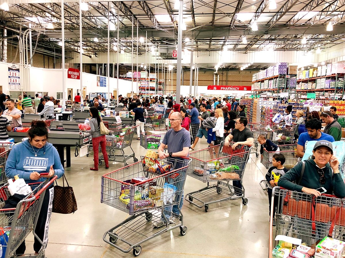 People waiting to checkout at the grocery store.