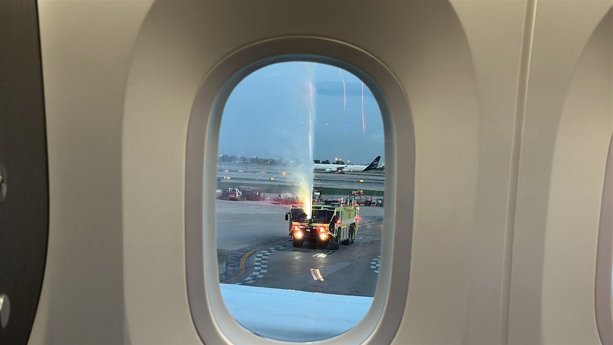 Fire truck shooting water onto the plane for a water cannon salute in ORD
