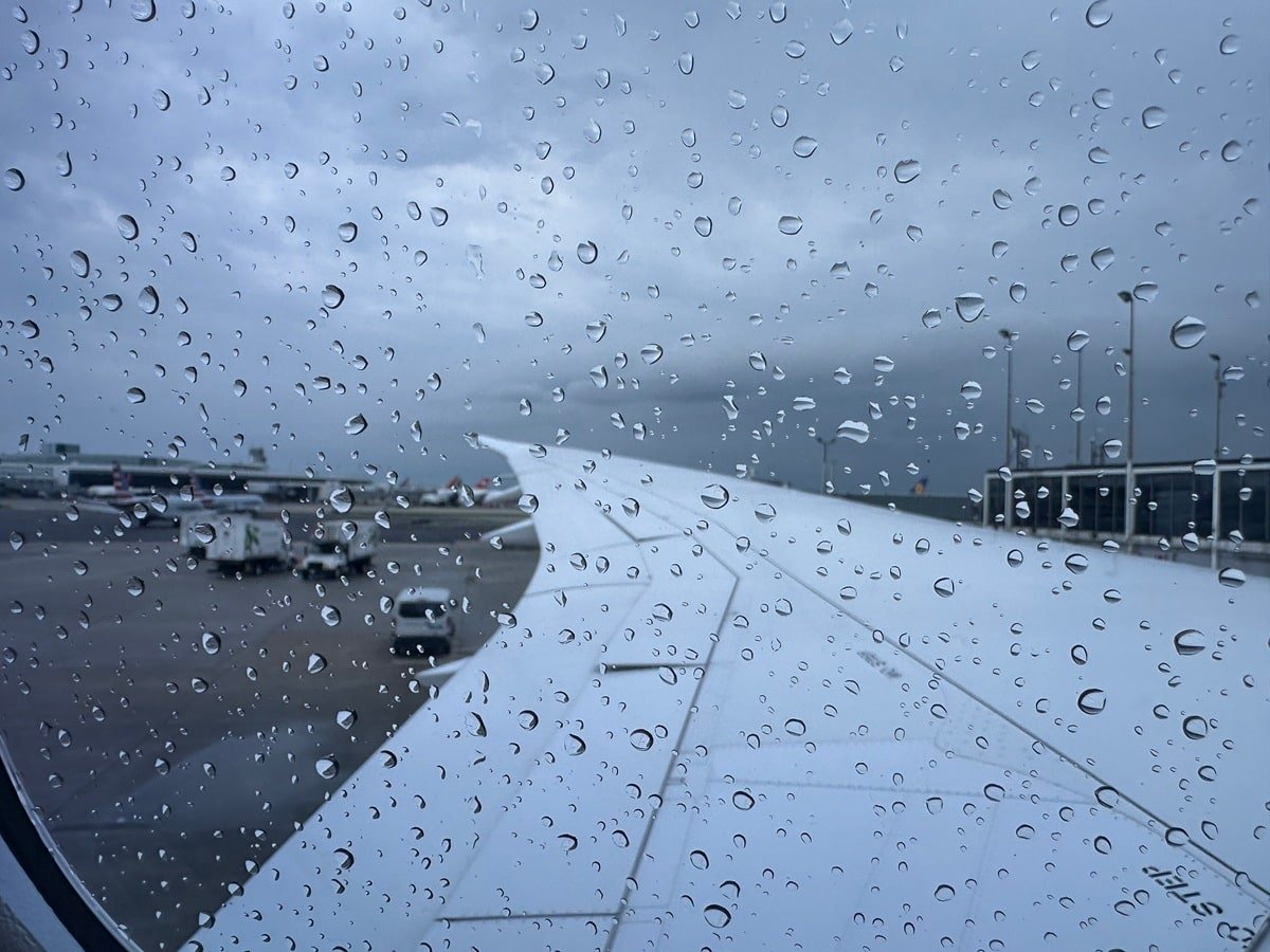 View out of a plane's window with rain drops on it