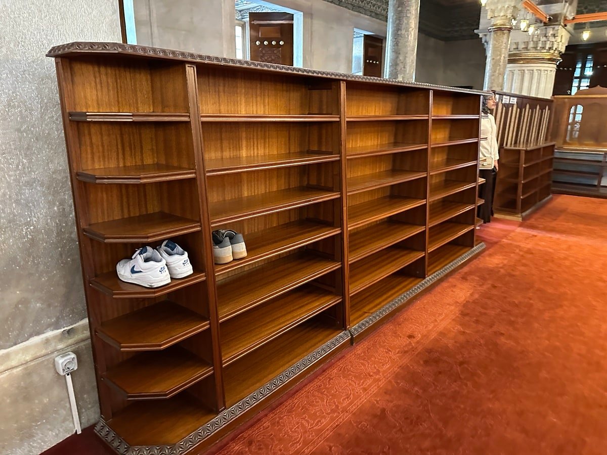 Photo of a shoe shelf in the Blue Mosque with just a couple pairs of shoes in them