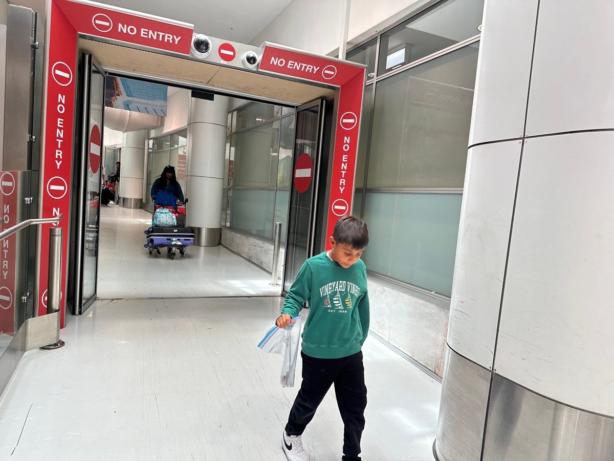 A boy clearing border control at Sydney International airport